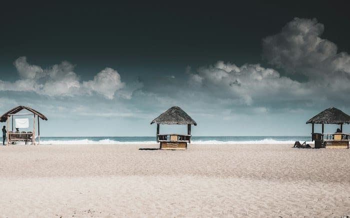 Beachside huts under an overcast sky