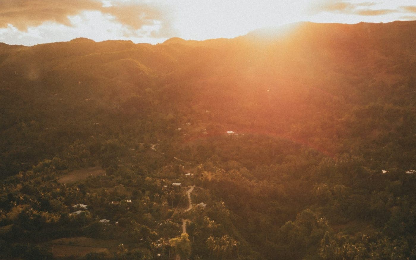 A winding road through green hills at dusk