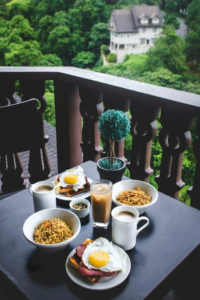 Breakfast on a balcony overlooking greenery
